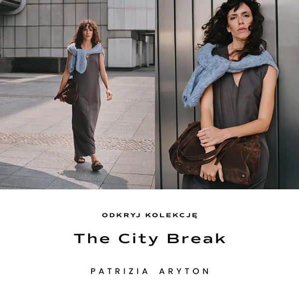 Kobieta w eleganckiej sukience na tle miejskiej architektury.