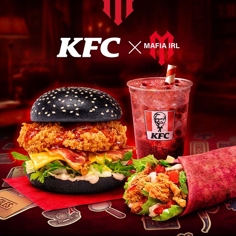 Zestaw KFC z czarną kanapką, napojem i wrapem.